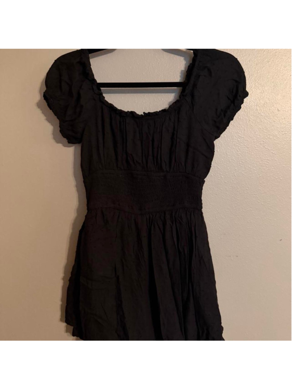 Black Hollister romper with subtle Swiss dot texture, short puff sleeves, scoop